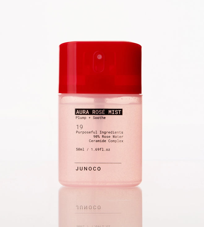 Pink bottle of Junoco Aura Rose Mist with red cap on a white background