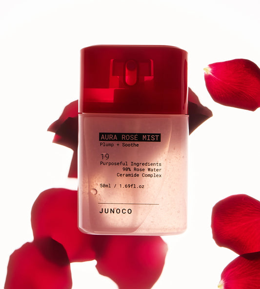 JUNOCO Aura Rose Mist bottle with red cap and rose petals on a white background